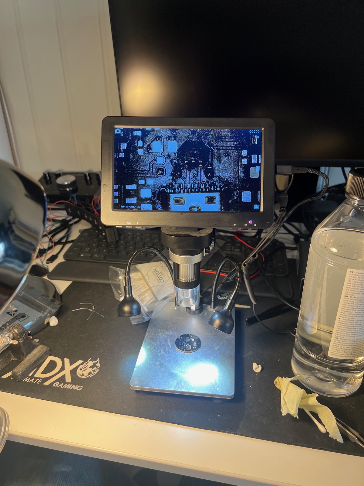 Checking joints under the scope. Every part on this board was placed and soldered by hand.