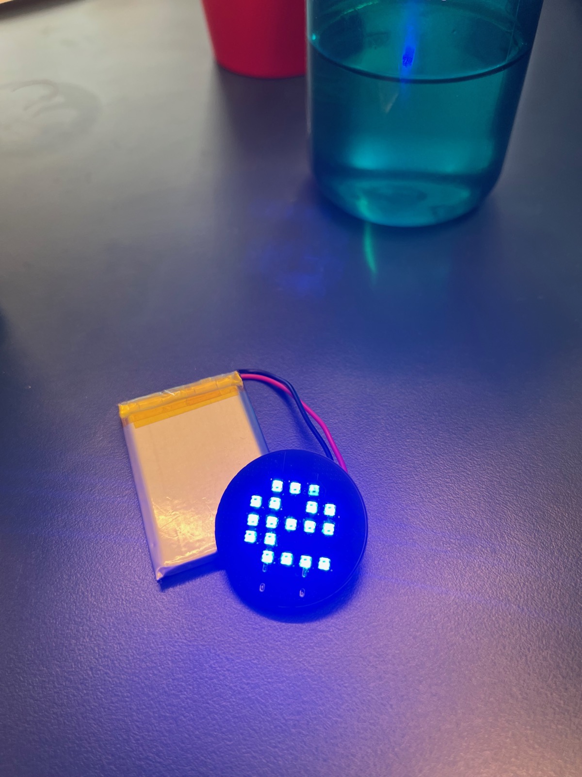 Board and LiPo, face up. Eighteen LEDs in the Elektra "E" and nothing else on that side. Every other part is on the back.